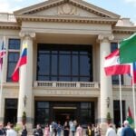 Embassy building with flags and people.