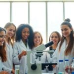 Women in lab coats with scientific equipment.