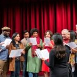 Playwrights of different backgrounds collaborate on a theater stage.