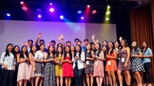 Diverse Hispanic youth celebrating on colorful awards stage