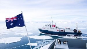 Australian and French flags on ship in Antarctic ice